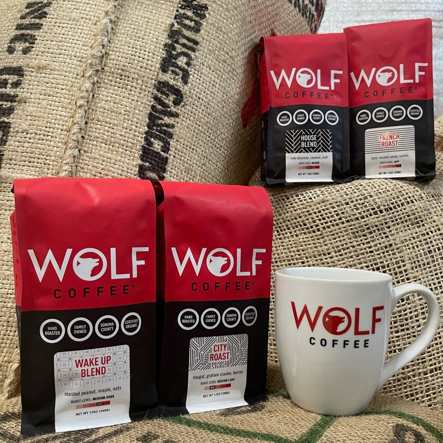 Wolf Coffee packages and a mug on a burlap background